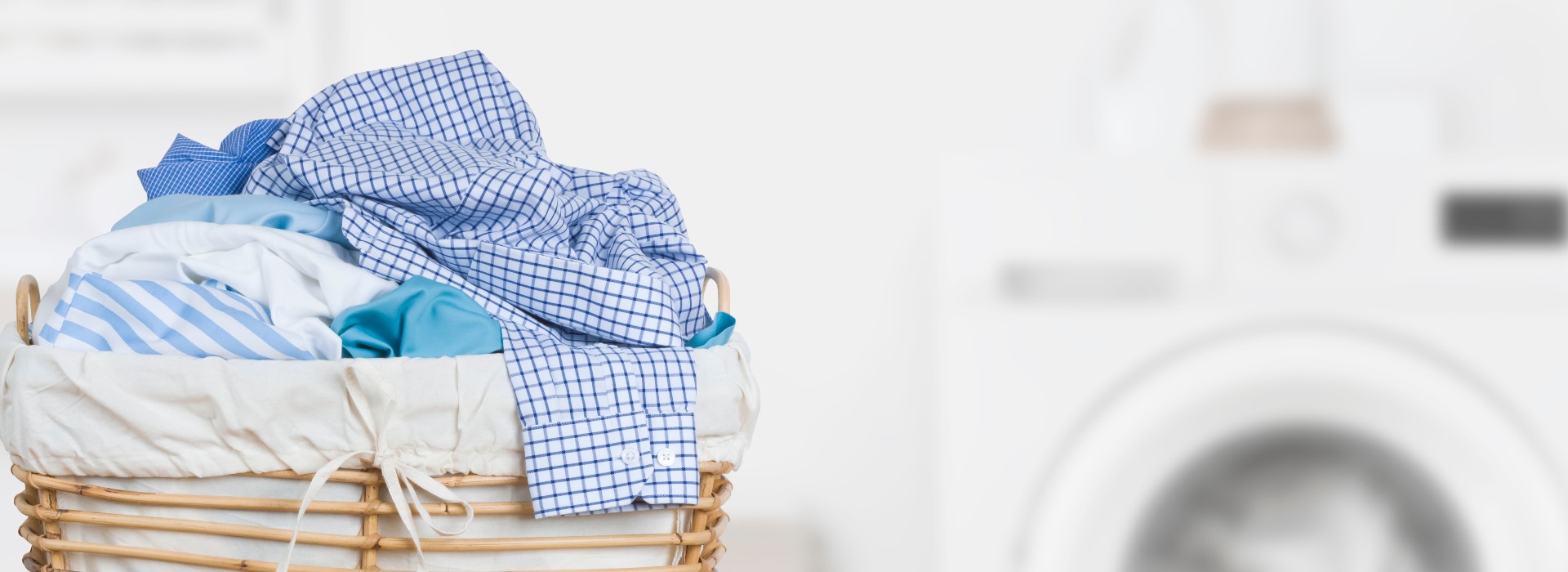 Laundry basket on blurred background of modern washing machine